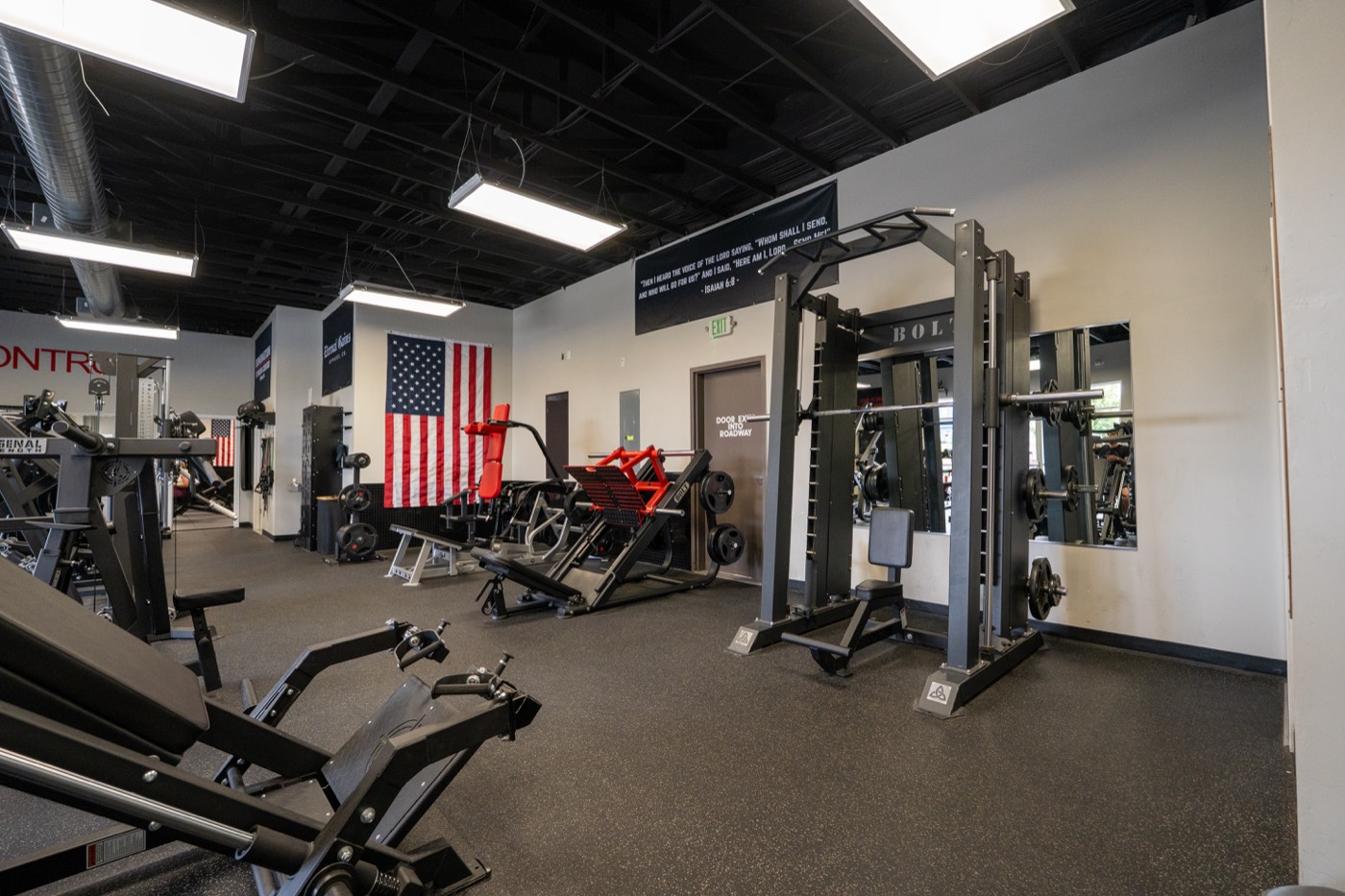 Training floor with red-accented plate-loaded machines