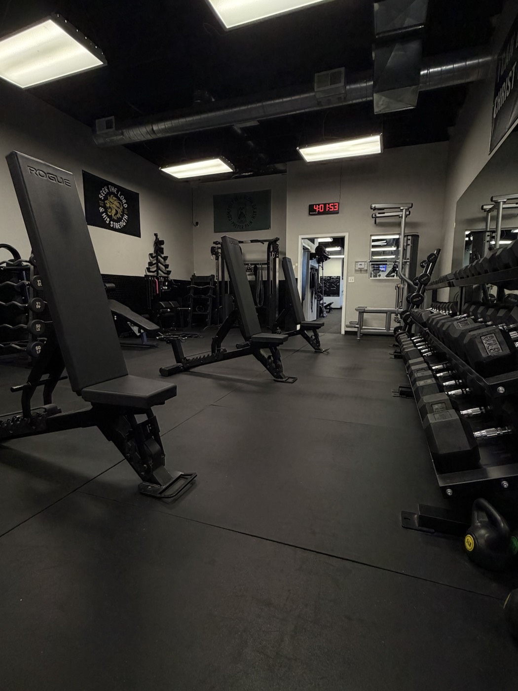 Adjustable benches beside the dumbbell rack