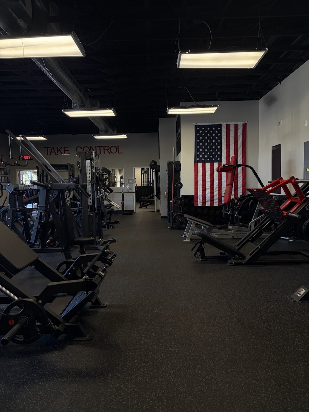 Red hack squat machine under the American flag