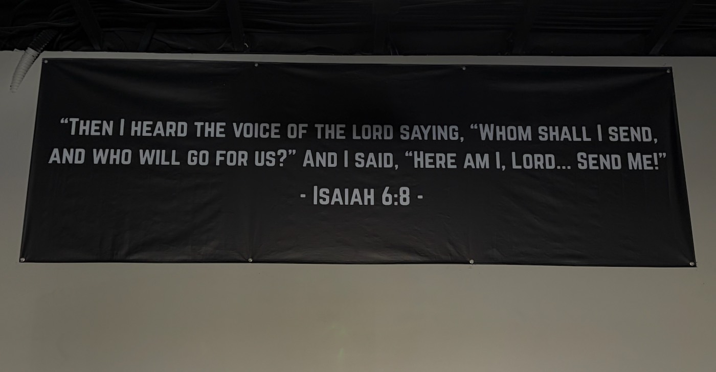 Isaiah 6:8 banner on the gym wall
